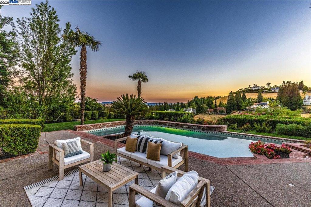 Nestled at the end of cul-de-sac is a gorgeous 5 bed + office, 4.5 bath home above the 7th Hole of Blackhawk CC’s Falls course & features sweeping golf course & stunning sunset views. Surrounded by manicured landscaping, the home includes paid-off solar, 3 Tesla Battery Backup & an 8-car garage. Double door entry leads into a grand foyer w/high ceilings & a sweeping staircase. Formal living rm features a wet bar, gas FP & tall ceilings with abundant natural light & flows into a formal dining rm w/wood flooring & French doors to the backyard. Updated kitchen features wood flooring, solid wood cabinetry, slab countertops, SS appliances, island w/ prep sink & gas cooktop, dining area, bar seating & walk-in pantry—all overlooking the backyard. The family rm includes built-in cabinetry, FP, wet bar, & French doors. The office has built-ins & French doors - ideal for WFH. Primary suite offers backyard access, fireplace, high ceiling & large ensuite bath w/ sunken Jacuzzi tub, oversized shower, sauna, bidet, dual vanities, and 3 custom closets w/ built-ins. A mini kitchenette adds extra function to the primary suite area. All Jr. Suites w/walk-in closets & 5th bedroom includes kitchenette & laundry. Backyard features a pool, spa, multiple patios, gated side yard/dog run, storage +.