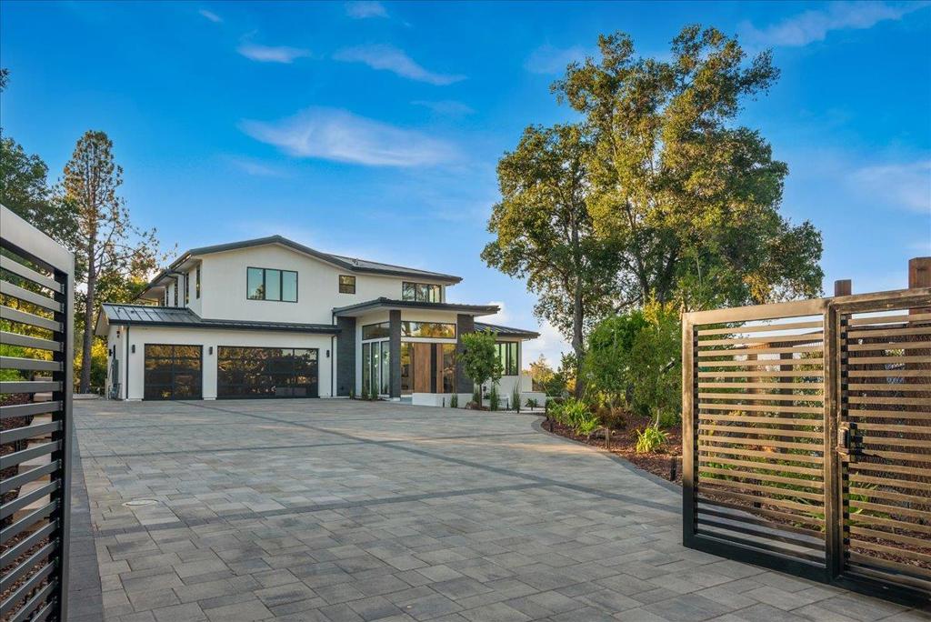 This modern Monte Sereno estate, spanning 6112 sqft on 1+ acres, showcases luxurious craftsmanship and new construction. Sustainable stone and wood details adorn the interior, blending well with the expansive grounds. Upscale amenities like an infinity pool, lanai, 3-car garage, and resort-style landscaping elevate the property. Nestled in the foothills, it offers captivating views, easy access to highways, downtown, and top-tier schools. The 3-level interior features a great room with glass walls, a private office, a family room with a premium entertainment setup, a dual island gourmet kitchen with Miele Pro range, a wine cellar, and 6 bedrooms with 5.5 baths, including an exceptional primary suite for an extraordinary lifestyle.