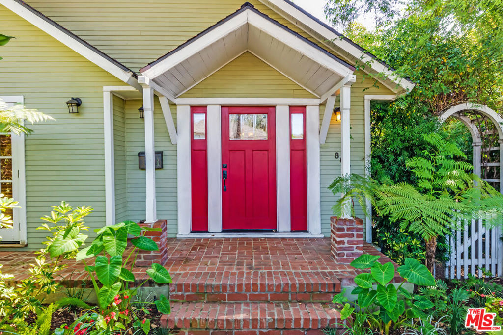 Incredible opportunity to reimagine an original California bungalow in the heart of West Hollywood's coveted Norma Triangle. This charming Cape Cod-style bungalow sits proudly on a corner lot framed by a white picket fence and lush, mature landscaping. Inside, the two-bedroom, one-bath home showcases timeless details vaulted ceilings, crown molding, and gleaming hardwood floors throughout. The spacious kitchen features stainless steel appliances, a breakfast area, and direct access to the backyard. French doors from the primary suite open to a serene deck and a Zen-inspired patio with a fountain surrounded by greenery a perfect setting for morning coffee or an evening glass of wine. Completing the property is a detached one-car garage (with parking for two) and an automatic gated driveway with access from Vista Grande.