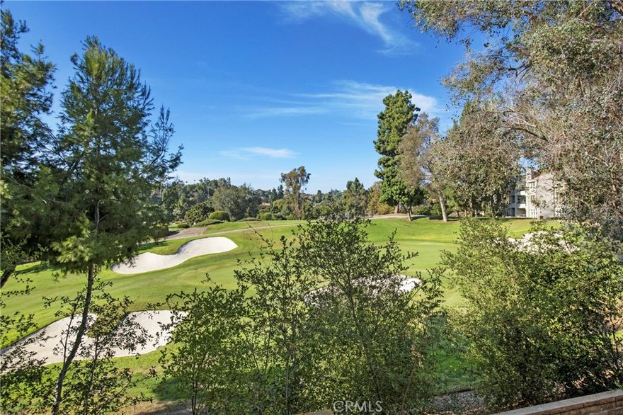 Welcome to Baja Finisterra on the Green—where privacy, convenience, and spectacular golf-course living come together.  2 Bedroom + Large loft (could easily be a third bedroom), PREMIUM LOCATION with this rare STREET LEVEL ENTRY residence, which offers easy access with NO STAIRS required to enter the home, and enjoys one of the most coveted positions in the community: an END UNIT directly ON THE 12TH HOLE with unobstructed, panoramic golf-course views framed by floor-to-ceiling living-room windows. Soaring vaulted ceilings and abundant natural light create an open, airy feel. The flexible layout features a primary suite, a secondary bedroom and bathroom, and a large loft that can be converted into a third bedroom. Enjoy a freshly painted interior, remodeled secondary bathroom, new commodes, plus laminate and tile flooring on the main level with carpeted stairs and a loft. The light and bright kitchen features quartz countertops, a stainless-steel farmhouse sink, a brand-new built-in wine cooler, designer lighting, and a convenient pass-through to the dining area. A sunny breakfast nook with an in-unit laundry closet accommodates full-size machines. Thoughtful flow makes entertaining easy, with an elevated dining area leading to the living room with a cozy fireplace and a quaint French door to the balcony. At the same time, multiple windows capture tranquil golf course vistas from nearly every room. Unwind and relax on the private deck, enjoying the birdsong and the gentle ocean breeze. The primary suite off the living room has its own slider to the balcony and a vaulted ceiling.
The ensuite bathroom features a dressing area and vanity, a large walk-in closet, and a walk-in shower. The association fees include water, trash, and a large enclosed spa with plenty of space for lounging in the sun. No mello roos and low tax rate. Street-level entrance, one-car garage with shelving, one assigned carport, and ample guest parking for ease and convenience. Lake Mission Viejo membership offers boat rentals, swimming beach, BBQ areas, playground, summer concerts, events, and more!  Proximity to shopping, dining, entertainment, and freeway access – this is a must-see!  Seller will pay $8,400 toward the buyer’s first year of H.O.A. fees with an acceptable offer.