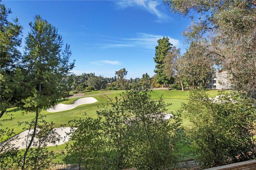 Welcome home to the gated community of Baja Finisterra On the Green! This peaceful and private end unit showcases a rare premium golf course location at the 12th hole, with panoramic fairway views framed by floor-to-ceiling living-room windows. Soaring vaulted ceilings and abundant natural light create an open, airy feel. The flexible layout features a primary suite, secondary bedroom and bathroom as well as a large loft that can be converted to a third bedroom. Enjoy a freshly painted interior, remodeled secondary bathroom, new commodes plus laminate and tile flooring on the main level with carpeted stairs and loft. The light and bright kitchen offers quartz countertops, a stainless-steel farmhouse sink, built-in Whyntr wine cooler, designer lighting, and a convenient passthrough to the dining area. A sunny breakfast nook with an in-unit laundry closet accommodates full-size machines. Thoughtful flow makes entertaining easy, with the elevated dining area to the living room with cozy fireplace and quaint French door to the balcony, while multiple windows capture tranquil golf course vistas from nearly every room. Unwind and relax on the on the private deck while enjoying the songs of birds and gentle ocean breezes. Primary suite off the living room has its own slider to the balcony, a vaulted ceiling, and the ensuite bathroom boasts a dressing and vanity area, large walk-in closet, and walk-in shower. The association fees include water, trash, and large enclosed spa with plenty of space for lounging in the sun. No mello roos and low tax rate. Steet level entrance, one car garage with shelving, one assigned carport and ample guest parking for ease and convenience. Lake Mission Viejo membership offers boat rentals, swimming beach, BBQ areas, playground, summer concerts events and more!  Close proximity to shopping, dining, entertainment, and freeway access – this is a must see!