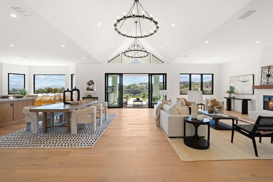 Set in Fallbrook’s exclusive Hill Ranch neighborhood, this brand-new modern farmhouse offers 4,488 SF of single-level living on 2.2 acres. Designed with both luxury and comfort in mind, the home features 4 bedrooms and 4 bathrooms, including a spacious primary suite with a spa-inspired bath and walk-in closet with custom built-ins. Each additional bedroom, including a second large primary-sized suite, enjoys its own fully improved walk-in closet, blending functionality with refined style. The open-concept layout showcases a chef’s kitchen with a large center island, Wolf appliances, and elegant finishes that flow seamlessly into the family room and outdoor entertaining spaces. Expansive windows frame sweeping views and allow natural light to fill the interior, while tasteful chandeliers throughout add timeless sophistication. A gated, tree-lined driveway, solar power, Kohler sinks, Toto toilets, and a generous 3-car garage complete the offering. With superb indoor-outdoor living and every modern convenience, this rare new construction estate embodies the best of luxury living.  No detail or expense was spared in selecting the finishes or appliances throughout the home. The kitchen features Wolf appliances and a Sub Zero refrigerator, all bathrooms are complete with Toto brand toilets and Kohler sinks. Hill Ranch is a gated community on the border of Bonsall and Fallbrook that is peaceful, quiet and easily accessible.