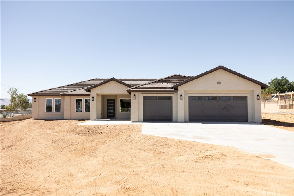 This stunning 4-bedroom, 2.5 bath property is located in prime location in Hesperia. Home offers 2,218 square feet of modern comfort, designed for both relaxation and entertaining. Flowing throughout this gorgeous home is wood-look tile floors which offers a warm appearance. The gourmet kitchen is equipped with top-of-the-line stainless steel appliances, ample cabinets, a walk in pantry, plus an oversized island, ideal for entertaining and family gatherings. The beautiful quartz countertops add a touch of sophistication to your kitchen and bathroom. The home was built with a spilt floor plan so the Primary bedroom is located on the opposite side of the home for privacy and comfort. The Master bedroom is generously-sized and master bath includes double sinks, a large custom walk-in shower, and walk-in closet that provides all the storage you need for your wardrobe and accessories. Also, the indoor laundry room has lots of storage This home offers an oversized three car garage and patio cover in the back yard. SOLAR IS PAID OFF! This lot awaits your personal touch, offering landscaping possibilities and ample space to create your own oasis. You will absolutely fall in Love with this home!