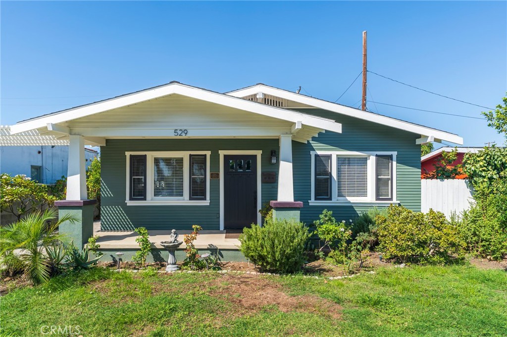 Mills Acted 1923 CRAFTSMAN bungalow. If you are looking for historic Anaheim at an amazing price, this is your home. Original residence was 2/1, but in 2011 a total renovation and addition brought this home up to size and modern standards without losing any of the period charm. The home was taken down to the suds and rebuilt, expanding both bedrooms and adding a primary with an amazing bath and inside laundry. All new PEX plumbing, tankless water heater, electrical (wiring and panel), redwood clapboard siding, 3 panel doors, moldings, hardwood flooring and custom shaker cabinets and granite counters. Beautiful new primary bedroom includes a walk in closet, dual sink vanity, walk in shower, linen closet and water closet. Both baths feature glass and ceramic tile. Rubbed bronze finishes, hardwood throughout kitchen, living room and hall. Huge laundry room at the rear takes you to a good sized back yard. All of this and a Mills Act that gives you up to 60% off your property taxes that will be passed on to the new owner. Rear access to property via an alleyway and double door vinyl fencing.