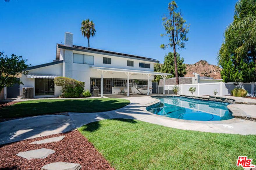 Incredible value for this fantastic home. The very best location, Las Virgenes School District, up off Valley Circle, across from expansive rolling hills, there is a wonderful sense of privacy and security. Impressive curb appeal with charming front porch where you and your guests relax over morning coffee or watching gorgeous sunsets. Perfect floor plan - downstairs bedroom or office opens to the backyard and has a bathroom with exterior access to the pool and a huge laundry/mudroom off the oversized garage. Main level open floor plan with living room, formal dining, kitchen and family room, all flowing together, all enjoying ample natural light and beautiful wood floors throughout. Upstairs two over-sized secondary bedrooms both have great closet space and wonderful views, while a third bedroom adjacent to the primary suite offers flexibility for a growing family. Numerous upgrades such as motorized shades, HVAC on NEST dual zoned, Ring Security System, Solar Power and EV Car Charger. The spacious backyard is anchored by a newly re-plastered pool. Enjoy the fabled outdoor California lifestyle year-round with outdoor BBQ, covered patio for al-fresco dining, and a grassy yard for pets and kids to play.