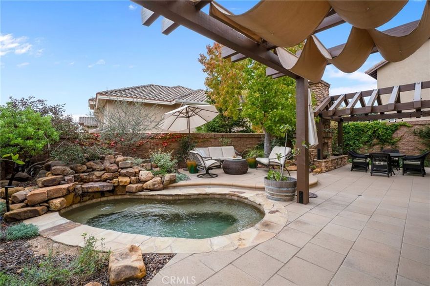 Immaculate in every sense, inside and out. Located in the highly coveted Pacific Ridge community, this beautifully upgraded home sits on a quiet and private cul-de-sac with no neighbor on one side. The property has been extensively remodeled with PEX repipe, real wood flooring, custom designer carpeting, crown molding, recessed lighting, upgraded window coverings, a built-in speaker system, and professional landscaping in both the front and back.Custom double entry doors lead into a light filled, open floorplan that immediately feels warm and inviting. The redesigned kitchen serves as the heart of the home and features vaulted ceilings with recessed lighting, a double oven, 5 burner cooktop, quartz countertops, a tile backsplash, white shaker cabinetry, stainless steel fixtures, and a large picture window overlooking the backyard. The layout blends spacious gathering areas with private retreats, creating a perfect environment for both everyday living and entertaining.Upstairs are 5 bedrooms, one of which is currently used as an office featuring a ceiling fan, balcony, and peaceful views.The primary suite offers vaulted ceilings, hill views, a large walk-in closet with mirrored doors, a soaking tub, separate stall shower, and dual vanities.The hall bathroom has been completely renovated with double sinks, quartz countertops, a frameless glass shower enclosure, and a window that brings in natural light. The backyard is a private sanctuary designed for entertaining, relaxing, and enjoying the natural beauty of Aliso Viejo.The space features an elegant spool with a tranquil waterfall, a gas fireplace, a concrete tile patio, and two patio covers providing comfortable outdoor living. More than 100 varieties of native plants and a collection of fruit trees including apricot, pomegranate, apple, lemon, lime, and kumquat create a lush and vibrant setting.The native landscape is water wise, low maintenance, chemical free, and resilient throughout the seasons. Ideally located close to the toll road, 5/405 freeway, shopping, theaters, restaurants, award winning schools, and only 3 miles from Laguna Beach. Pacific Ridge offers two playgrounds, two parks with baseball and soccer fields, two tennis courts, a basketball and sports court, and more than 22 miles of hiking and biking trails. The community is known for its pride of ownership, scenic hillside views, and tranquil surroundings that create a peaceful environment minutes from everything Orange County has to offer.