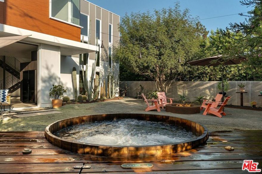 In the heart of Culver City's coveted Carlson Park, this newly built modern oasis on a 7,500+ sq ft lot blends design and soul, where artistry meets everyday living. Every detail has been curated for comfort, beauty, and connection, creating a home that feels as effortless as it is refined. You will fall in love the moment you enter this 4 Bdrm/3 Bath residence and are greeted by natural light flooding the dramatic 21-foot great room. The space connects seamlessly to a chef's kitchen with a leathered black-granite waterfall island, Sub-Zero/Wolf/Miele appliances, custom cabinetry, and a 364-bottle EuroCave wine cellar. The open layout invites entertaining and family connection, while wide sliders reveal a lush yard designed by Big Red Sun, complete with sustainable landscaping, custom steelwork, a Japanese-inspired cedar onsen hot tub, and a built-in gas fire pit for nights under the stars. The generous lot is one of the largest on the block - offering privacy, room to play, or space to add a pool. Thoughtful main-level living provides forever-home flexibility, featuring zero-threshold entries, extra-wide doorways, and a guest suite ideal for visiting family, an au pair, or executive workspace. Upstairs, the tree-lined primary suite evokes spa-like tranquility with a luxurious bath and custom walk-in closet. Two additional bedrooms each feature private, primary-caliber baths and abundant natural light. Modern technology and sustainable features enhance daily life, including 44 owned solar panels, full smart-home integration with pre-programmed scenes, Lutron automated lighting and shades, and an oversized garage with 10-foot ceilings, ample storage space, and dual EV chargers. Just steps from Carlson Park and a short stroll to Downtown Culver City's acclaimed restaurants, boutiques, and cafes, this location offers the best of Los Angeles living. Enjoy weekends at The Culver Steps, The Platform, or the nearby Arts District, with Erewhon, Trader Joe's, and the Farmers Market all minutes away. Families love Culver City's award-winning schools, while professionals appreciate easy access to major tech hubs, studios, the Expo Line, and freeways. More than a home, it is a rare opportunity to join a close-knit community in one of LA's most desirable neighborhoods, where creativity, convenience, and connection thrive.