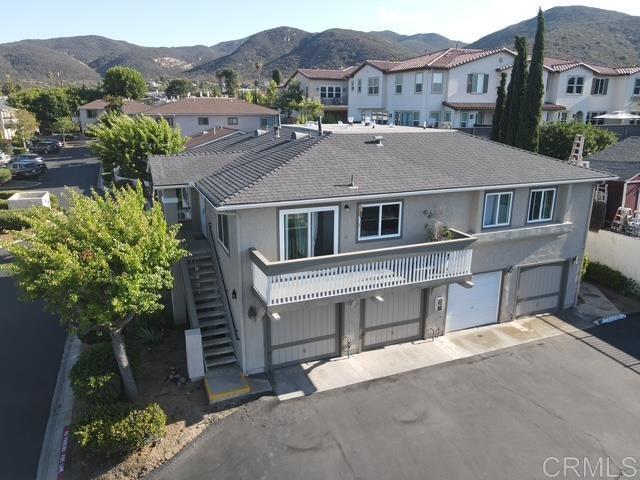 CHARMING UPDATED CONDO WITH THE BEST VIEW IN THE COMPLEX IS A MUST SEE! As you enter into the living room, you’ll immediately notice plenty of natural light, newer wood-laminate flooring and neutral color scheme. Remodeled kitchen features plenty of cabinet space new doors & drawers, quartz countertops, tile backsplash, and black appliances. Separate dining area with walk-out access to balcony is perfect for entertaining. Spacious balcony with 180-degree view of north Santee overlooks the pool. Luxurious primary suite fresh paint with adjoining full bath and walk-in closet. Secondary bedroom has a 3/4 bath just steps away providing separate closet for stackable washer/dryer OR side by side in the garage. Bathrooms have new vanities, light fixtures and flooring. This upper-level condo sits above garages so there’s no one above or below! One-car garage with opener PLUS an additional assigned parking space and guest parking scattered throughout complex. Other features include: NEW dual-pane vinyl windows, NEWER wood-laminate floors, NEWER water heater, NEW interior doors, NEW central A/C for added comfort, NEW carpet AND paint in bedrooms. Well maintained VA/FHA-approved complex with low HOA dues! Easy access to freeways, shopping, restaurants, great schools and more! If you like to hike & bike, Cowles Mountain, Mission Trails, Oak Canyon and Santee Lakes are minutes away!