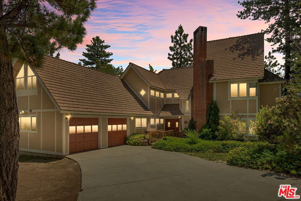 This extremely spacious and stylish 5 bedroom, 4 bath level entry home in Lake Arrowhead Woods has everything you could want in a mountain retreat. Currently a successful short term rental, it is located in North Bay near Tavern Bay Beach Club and UCLA Conference Center, and within a 10 minute drive to Lake Arrowhead Village. This 3 level home was recently remodeled, and comes fully furnished with an eclectic blend of new and antique decorator pieces. The entry level features an open concept living dining area with wood burning fireplace, large updated kitchen for family and friends to cook gourmet meals, one bedroom, newly tiled and renovated bathroom, office and laundry. An inviting outdoor deck completes this floor, with lounge seating, dining, fire pit, and a hot tub perfect for entertaining. The second floor showcases the grand primary suite, with a lovely light filled sitting area, a remodeled bathroom featuring designer finishes, fixtures, and custom marble vanity, an upper loft with storage, three closets, and a private balcony to view the picturesque treetop views and mountains. This 2nd floor level has two additional bedrooms and a renovated bathroom with Kohler soaking tub, along with a wonderful A-frame media game-room with pool table. The lowest level of the home features an additional bedroom and bathroom, accessed either by a 2nd staircase, or through a separate outside entrance. Additional amenities and features of the home include a whole house Generac generator, alarm/video camera system, tankless water heater with back up water heater, 3 floor zoned hvac with nest thermostats, and plenty of level entry parking, including space for an RV. This modern rustic fully furnished home with lake right provides the new owner with so many options: keep as a STR investment, use as a 2nd home for extended family getaways, or enjoy the beautiful mountains year round as a primary residence.