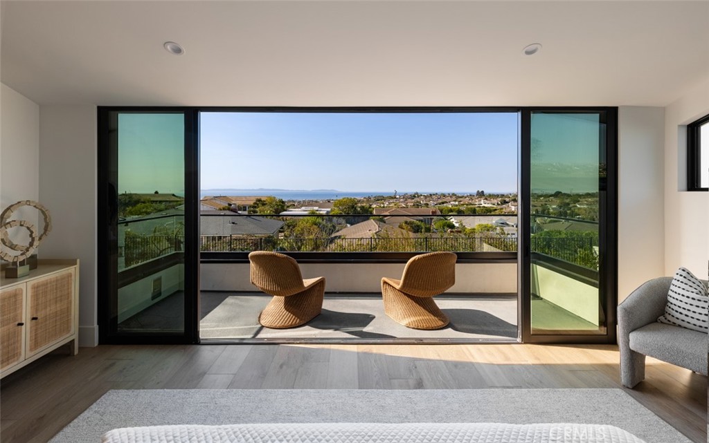 Crowning an incomparable elevated homesite that allows gorgeous ocean views from the first floor and breathtaking Catalina Island, city-light and coastline vistas throughout, this brand-new custom home presents the ultimate lifestyle experience. Thoroughly reimagined, rebuilt and expanded by SkySail Coastal Estates, the residence is located in Corona del Mar’s prestigious Harbor View Hills South community and captures the eye with sophisticated Modern Traditional architecture. A blend of mature and fresh landscaping embellishes a welcoming gated front-yard that includes an open-air fireplace and ample room for gathering with friends and neighbors. Soaring two-stories high, the foyer is illuminated by a massive window and leads to a fireplace-warmed family room with vaulted ceiling and bi-fold doors opening to the front patio, and a spacious dining room with backyard access. Ready for the pages of Architectural Digest and Dwell, the open design’s chef-inspired kitchen is on-trend and state-of-the-art, displaying custom two-tone cabinetry, Walker Zanger quartzite countertops, open shelving, and island and French doors to the backyard. Top-tier appliances from Wolf, Cove and Sub-Zero are unparalleled, and the butler’s pantry is magnificent in style and detail. The first level also hosts a guest bedroom, large office with fireplace and built-ins, and an attached three-car garage. Approximately 4,500 square feet, the generously proportioned residence reveals four ensuite bedrooms, four- and one-half baths, and a versatile loft with ocean views and a built-in Wolf coffee center. Enjoy romantic Pacific panoramas in an opulent primary suite that carefully incorporates contemporary upscale design to create a soothing, peaceful retreat. A vaulted ceiling, custom fireplace, expansive walk-in closet, freestanding bathtub, marble finishes and a rain shower with custom enclosure are showcased. Guests will feel equally at home in brand-new detached ADU of 507 s.f. with a private bedroom and bath, kitchen with induction cooktop, and a living area with bi-fold doors to the patio. Sweeping ocean views emphasize the home’s ocean-close setting on a premium lot of almost 10,000 square feet. Experience memorable moments in an all-new backyard with pool, spa, fire pit, sprawling limestone patios, and a kitchen with Lynx grill, refrigerator and ice maker. Beaches, Fashion Island, top schools, and high-end shopping and dining are merely minutes from home.