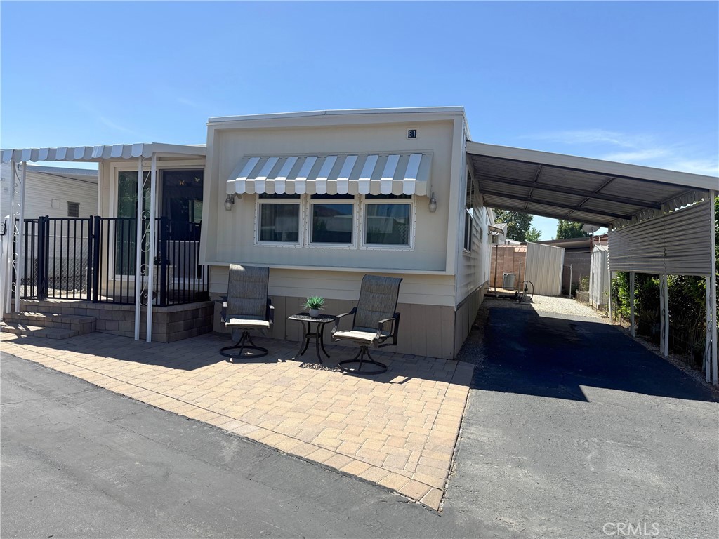 This FULLY FURNISHED mobile home is located in the Northview Mobile Home Park in the North Bench. When you arrive, you’ll notice the attractive exterior pavers all along the front, which give it a nice curb appeal that also showcases a cozy sitting area. This beautiful well cared for home has 2 bedrooms, 1 bathroom and offers an amazing amount of storage throughout. It includes 3 closets, one of which is an astonishing 12 foot wide. The bathroom and hallway have great storage with deep shelves from ceiling to floor. One bedroom has built in drawers with a total of 12 drawers. The upgraded double pained windows and sliding door offer great energy efficiency. You’ll be pleased with the large ‘indoor’ laundry room that has enough space to add a folding table and/or shelving. The covered shaded carport is great during the hot summer months and rainy season. The space allows for 2 full sized vehicles. The 2 sheds are large enough for your bins, tools, and seasonal decorations, keeping your home clutter-free. All appliances and furniture are included. Hurry this home won’t last. It’s a must see.