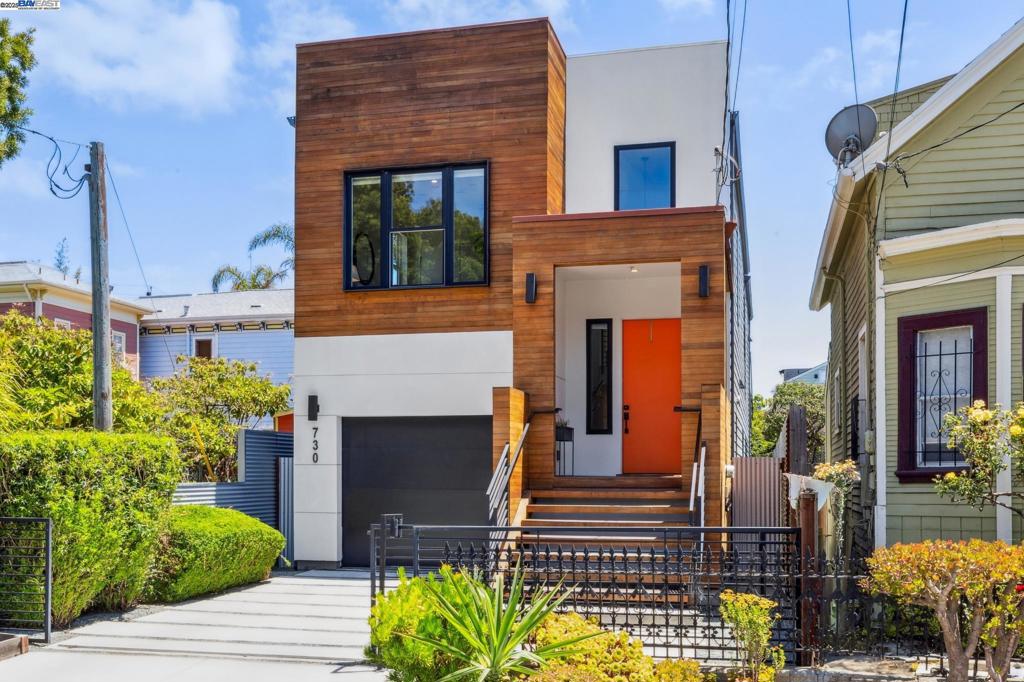 Enjoy impeccable modern design and worry-free systems in this 2020 construction home with 2586 SQFT of brilliant open spaces and indoor/outdoor living. An inviting covered porch welcomes you inside this expansive 4BD/3BA home where windows galore bathe the open floor plan with sunlight. Gorgeous hardwood floors lead from the living room, to the dining area, and ultimately to the custom kitchen with its European style cabinetry and huge island with seating. Sliding glass doors open onto a big deck where you can dine al fresco or relax in peace with your morning coffee. The ground floor includes a bedroom and full bath with designer tiling. Downstairs, three more bedrooms are tucked away for privacy and quiet. Two bedrooms share a jack-and-jill bath, while the primary bedroom offers a luxurious ensuite bath. Enjoy the backyard with plenty of space to entertain or play, and an additional flexible space awaits for workouts, playroom, or office. The lower level also offers laundry and interior garage access, with more parking in the gated driveway. Commuting couldn’t be easier with BART and various options nearby. Weekly farmers market, the new Prescott Market, Oakland Ballers stadium, downtown Oakland, Emeryville, and Jack London are close for dining, shopping, & entertainment.