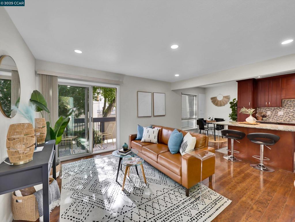 End unit, bright & airy, 2-story condo/townhouse style at Comstock Gardens featuring 2 bedrooms, 1.5 bathrooms with plenty of renovations to accommodate modern living. No neighbors below or on top of unit. Double pane windows with new coverings. Remodeled, upgraded kitchen with gas stove & granite counter tops. LED, energy efficient recessed lights on ceilings. Wood laminated floors. New stairway carpets. Central AC and heating systems. 1-car garage directly underneath with remote control access and additional storage closet. Community pool. Hot water service included within HOA fees. This unit is located in close proximity to shopping, public transportation and a variety of community services. Virtual tour at https://my.matterport.com/show/?m=u4Lg2xyzkd5
