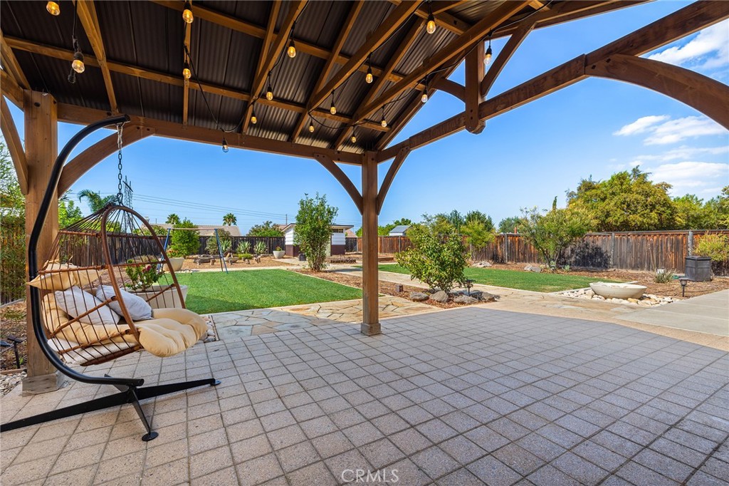 Discover this wonderful single-story home featuring 3 bedrooms, 2 bathrooms, and a spacious 3-car garage, all situated on a beautiful quarter-acre lot. The third room is designed as an office/den but the current owners have been using it as a bedroom, showcasing its versatility to meet your specific needs. Enter through the front door into an elegant formal living room that flows seamlessly into the formal dining room, perfect for entertaining guests. The heart of the home features an updated kitchen with painted cabinets showcasing beautiful hardware, upgraded appliances, and stunning granite countertops that overlook the inviting family room. The home also includes a convenient laundry room with sink for added functionality. The family room boasts a cozy fireplace and includes a convenient kitchenette area, making it ideal for casual dining and relaxation. Step outside to discover the true gem of this property – an amazing, expansive backyard that offers endless possibilities. The outdoor space features a beautiful pergola, charming garden boxes for the green thumb enthusiast, stunning hardscaping, and an adorable storage shed. This exceptionally private oasis has no neighbors overlooking the yard, providing complete seclusion for outdoor entertaining, relaxation, or family activities in your own tranquil retreat. Location is key, and this home delivers with its proximity to recreation – just one house away from a wonderful neighborhood park, perfect for morning walks, family activities, or simply enjoying the community atmosphere. Additional features include a whole house fan system for comfortable year-round living and energy efficiency. This property combines comfortable indoor living with exceptional outdoor space, making it perfect for those seeking both privacy and community convenience.