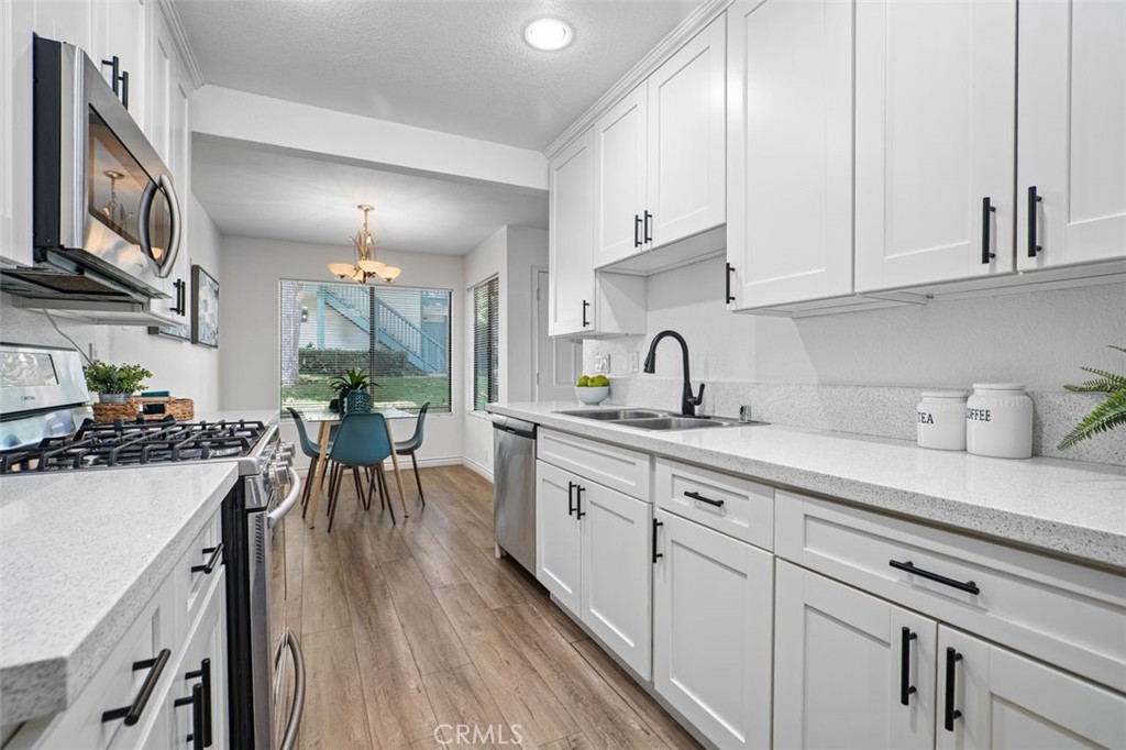 Welcome to Ponderosa West, a gated community offering a serene, resort-like lifestyle at an excellent value.
This single-level ground-floor condo features two bedrooms and two bathrooms, including a primary suite with an attached bath and a spacious walk-in closet. The remodeled kitchen is finished with white shaker cabinets, quartz countertops, and recessed lighting, and it opens to a dining area and a generous living room that flows seamlessly to a private patio—perfect for relaxing, entertaining, barbecuing, or enjoying with pets. The home also includes laminate flooring throughout and the convenience of a private washer and dryer inside the unit.
The community is beautifully maintained with winding walkways, charming bridges, flowing streams, and a tranquil pond, creating a peaceful setting that feels worlds away from city life. Residents enjoy two swimming pools, two spas, and pet-friendly grounds with plenty of space to stroll.
Parking is simple with two assigned shaded spaces located a short walk from the unit, along with abundant guest parking for visitors.
Centrally located near major freeways, hospitals, LAX, SoFi Stadium, shopping, and dining, this home combines modern comfort with a secure, welcoming community and exceptional convenience - making it a smart opportunity in the South Bay.