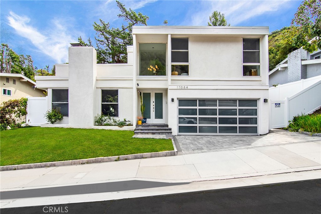 Incredible "South of Blvd" contemporary showplace nestled within the tranquil hills of Encino unlocking access to sought after Lanai elementary. Stunning renovation affords a dazzling kitchen with custom cabinetry, quartz counters, herringbone marble backsplash & quality Viking appliances opening to a spacious family room & ideal adjacent dining. Open & bright living room is enhanced by high ceilings, romantic fireplace & an incredible custom built-in. Savor gorgeous European oak floors throughout. Distinct staircase with floating wood stairs & glass is sure to please. Your primary suite features a luxurious private bath, large walk-in closet & impressive floor to ceiling windows framing a serene vision of the lush green surroundings. Two additional bedrooms each offer walk-in closets with custom organizers. Impressive hall bath & lower-level powder room complete this amazing interior. Finished two-car garage is equipped with an electric car charger & spectacular glass door. Outside, enjoy private rear woodsy grounds. Super easy westside access & mere moments to Gelson's & all the shops & yummy eateries that line the Blvd. This is truly one you won't want to miss!