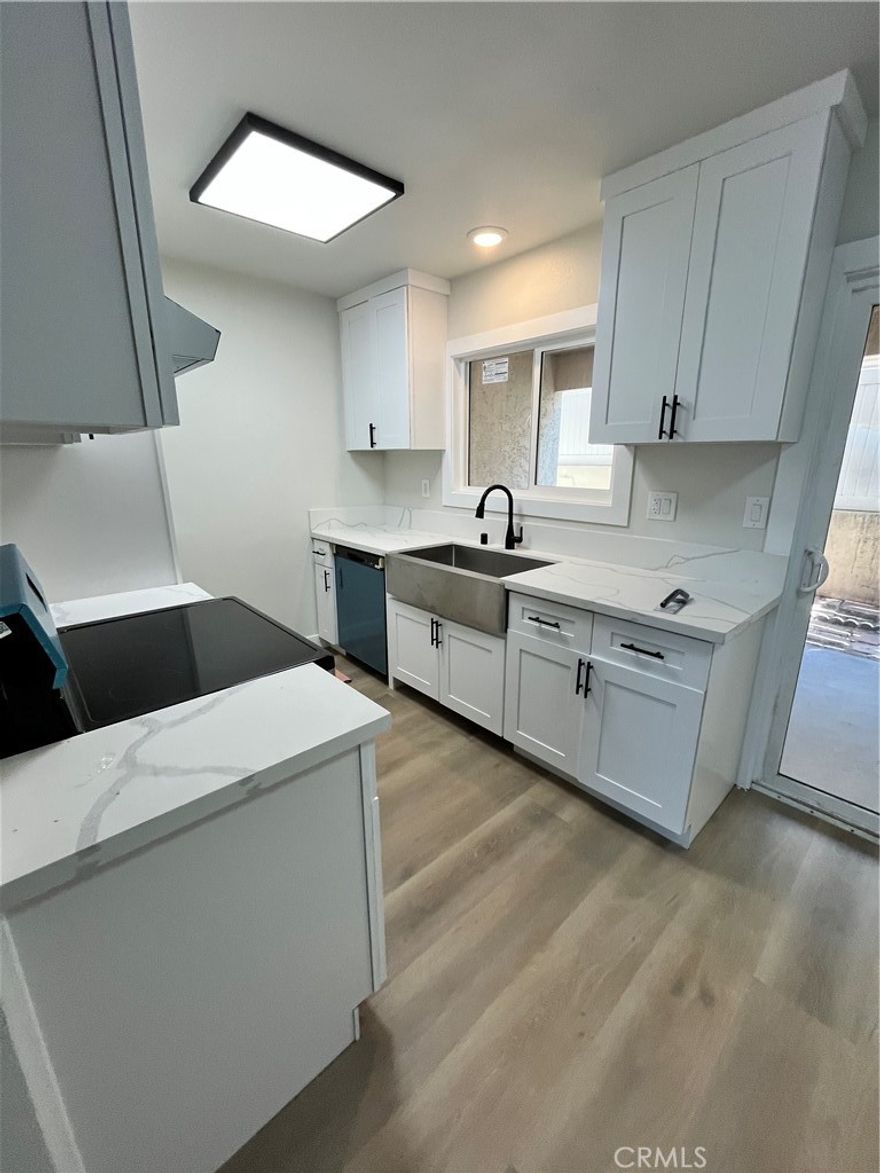 Beautifully remodeled townhouse style unit.  Remodeled kitchen and baths with new cabinetry and quartz countertop, new vinyl plank flooring, new paint. Includes a two-car garage.  Spacious open patio off the kitchen.