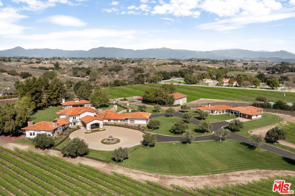 Nestled on just under 25 acres of premier wine country, this exceptional Santa Ynez vineyard compound offers a blend of luxury, privacy, and viticultural prestige-- all nestled behind gates, and ripe with opportunity for a vintner to continue its legacy. Ideally located just a short distance from the charming town of Los Olivos, and Mattei's Tavern, The Vincent Vineyards Estate is well positioned for high visibility on the scenic SR-154. The heart of the property is a meticulously built 6-bedroom Italianate villa, thoughtfully designed with timeless elegance and panoramic views of the surrounding vineyards and expansive backyard and grounds. This main residence features luxurious en-suite bedrooms, a breakfast room, an elevator, an exercise room, and a primary suite with dual closets and spa-like bathrooms. Complementing the main home are two well-appointed guesthouses featuring 3 additional bedroom suites, spacious living areas, and gourmet kitchens, ideal for extended family or visitors seeking privacy and comfort. A haven for wine enthusiasts and collectors alike, the estate boasts 14 acres of meticulously maintained and imported Bordeaux varietals, supported by a fully equipped onsite winery and tasting room - perfect for private label production or continuing its commercial operation. With dozens of 90+ pt wines and countless accolades, this is an incredibly rare opportunity for a wine enthusiast to truly own and experience the quintessential 'Vintner Lifestyle'. Additional amenities include a stunning pool pavilion and cabana with chef's kitchen and bar, ideal for relaxed entertaining, and 7 garage spaces for the true car enthusiast. Positioned in one of the most coveted corridors of the Santa Ynez Valley, this estate offers the perfect blend of luxury living and agricultural opportunity, just minutes from acclaimed restaurants, tasting rooms, and the vibrant lifestyle of Los Olivos and Santa Ynez.