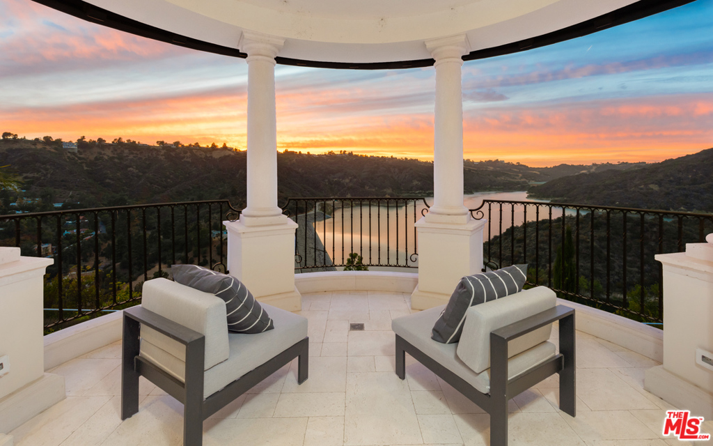 Sited behind gates at the end of a cul-de-sac, this exquisite Villa exudes elegance and Italian style in prime Bel Air with shimmering vistas of the Stone Canyon Reservoir. Enter through the double doors into a soaring foyer complete with ornate stone and woodwork that leads to a voluminous formal living room, dining room and wood-paneled office, all with french doors that open to outside terraces and views of the reservoir. Highlights include a gourmet kitchen, cosy den with coffered ceiling, an elevator and smart-home technology. The resort-like master suite includes dual bathrooms and closets, and beautiful outdoor balcony with city views. An entertainers paradise awaits on the lower level, with indoor pool/spa, home theater, billiard room, climate controlled wine cellar and subterranean garage. Expansive grounds host a multitude of patios, lush lawns and landscaping, an outdoor kitchen and sparkling infinity edge pool, all encompassed by the finest views LA has to offer.