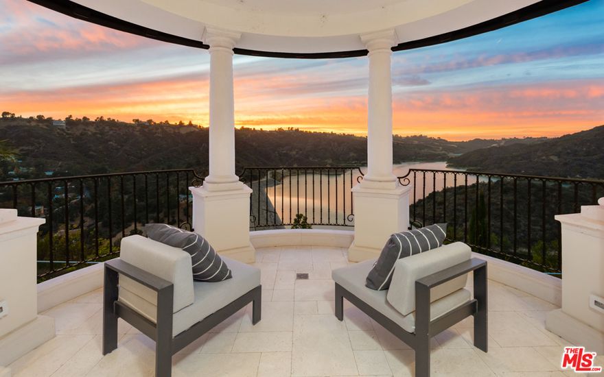 Sited behind gates at the end of a cul-de-sac, this exquisite Villa exudes elegance and Italian style in prime Bel Air with shimmering vistas of the Stone Canyon Reservoir. Enter through the double doors into a soaring foyer complete with ornate stone and woodwork that leads to a voluminous formal living room, dining room and wood-paneled office, all with french doors that open to outside terraces and views of the reservoir. Highlights include a gourmet kitchen, cosy den with coffered ceiling, an elevator and smart-home technology. The resort-like master suite includes dual bathrooms and closets, and beautiful outdoor balcony with city views. An entertainers paradise awaits on the lower level, with indoor pool/spa, home theater, billiard room, climate controlled wine cellar and subterranean garage. Expansive grounds host a multitude of patios, lush lawns and landscaping, an outdoor kitchen and sparkling infinity edge pool, all encompassed by the finest views LA has to offer.
