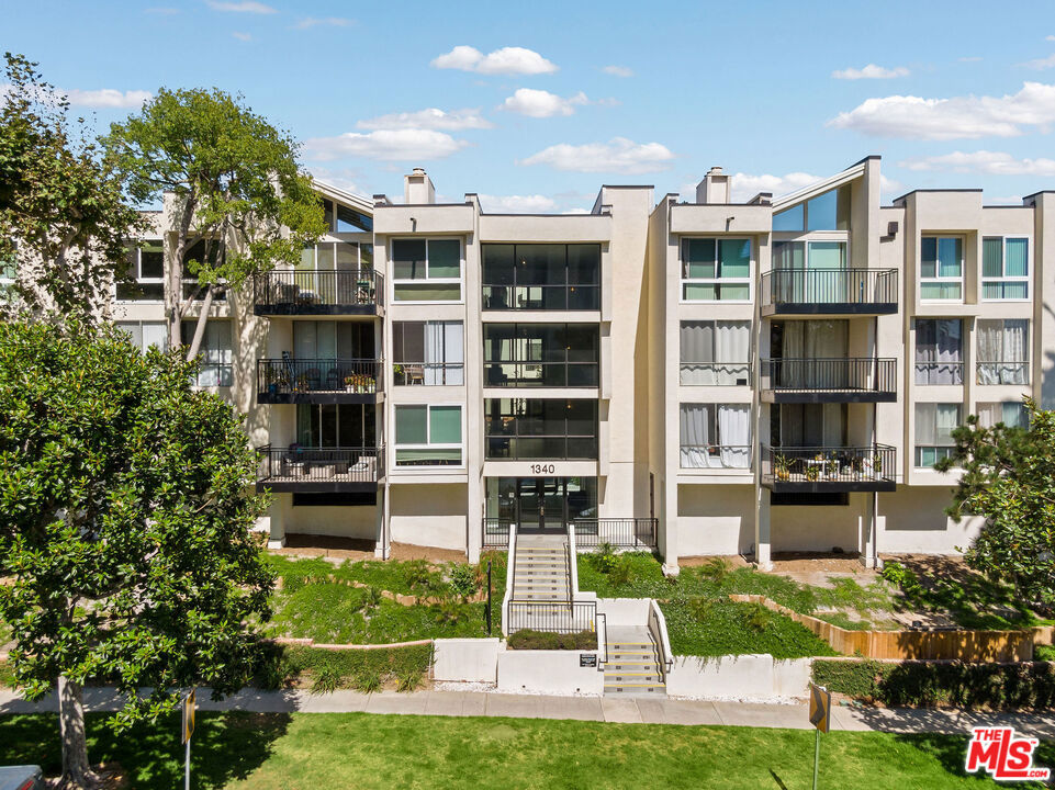 Tucked away from the bustle of Beverly Glen, this beautifully updated single-level condominium offers a tranquil rear courtyard setting with a seamless blend of elegance and modern style. The spacious living room opens to a patio overlooking lush greenery, an ideal backdrop for relaxing or entertaining. A cozy den with a striking fireplace serves as the perfect flex space for work or leisure. The expansive primary suite features an en-suite bath with dual sinks, a generously sized walk-in closet, and a custom vanity. The well-appointed galley kitchen includes stainless steel appliances and a wine cooler, with the in-unit washer/dryer discreetly housed in a nearby closet . Thoughtful upgrades include recessed lighting, double-pane windows, updated flooring, custom closet built-ins, and a new HVAC system . Community amenities include a secured entry, elevators, pool, spa, two side-by-side parking spaces, and private storage in the gated garage. With a future Metro stop nearby and easy access to Century City, UCLA, Beverly Hills, Santa Monica, and the beach, this is an exceptional opportunity to enjoy comfort, convenience, and Westside living at its best. Available September 20th.