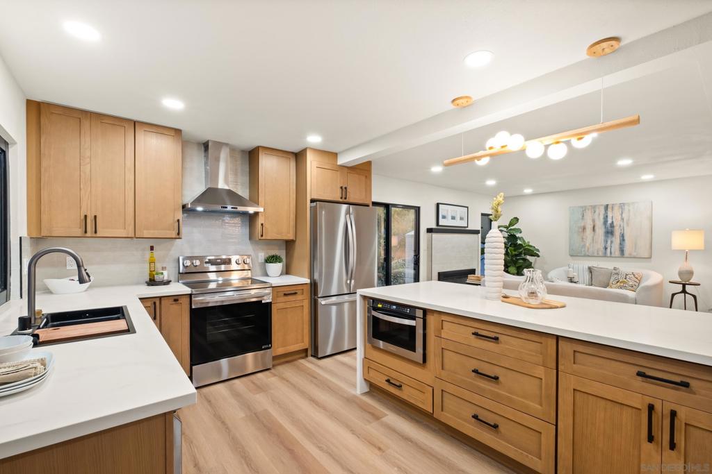 Stunningly remodeled 4-bedroom, 3-bath home on a generous 0.24-acre corner lot in coveted West Mount Helix! This La Mesa gem blends modern style with everyday comfort. The thoughtfully designed layout includes a desirable downstairs primary suite with full bath, plus three additional bedrooms and two baths upstairs—including a second primary suite for ultimate flexibility. The upgraded kitchen boasts quartz countertops, new appliances, and designer finishes, while spacious living areas are filled with natural light. Enjoy year-round comfort with central AC, relax on the covered patio for outdoor dining, and take advantage of a private, low-maintenance backyard with gated RV/boat parking. Mature trees frame the large front yard, and the oversized 2-car garage offers ample storage. Ideally located near top shopping, dining, parks, and entertainment—with quick freeway access—you’ll have the best of La Mesa right at your doorstep.