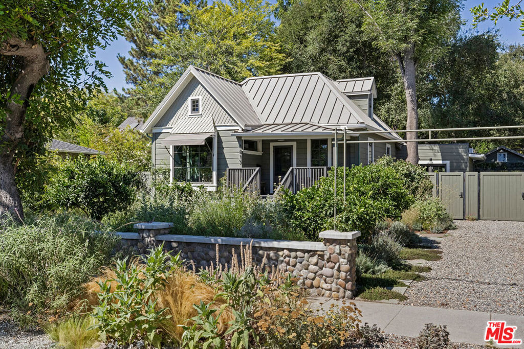 In the Linda Vista neighborhood of Pasadena, this stunning 1895 Farmhouse Cottage with a sparkling pool weaves together old-world charm and modern updates in a magical garden setting. Expansive layout flows across two levels, featuring an oversized living room, a sunken dining room with French doors that spill into the yard, and an office lined with bookshelves; wood floors run throughout. The remodeled English-style kitchen is a bright space with soapstone countertops, pantry storage and stainless appliances. Bedrooms provide versatility, including a spacious en-suite primary and an attic-style bedroom with a powder room; bathrooms are freshly appointed with period details. The front porch is a breezy spot for morning coffee, and the gated yard offers a tranquil environment for entertaining or quiet escape by the pool and spa. Amenities include a detached two-car garage, outdoor shower, central AC, and basement storage. The great location puts you near the Rose Bowl, Art Center, Brookside Golf Club, and hiking in the Arroyo.