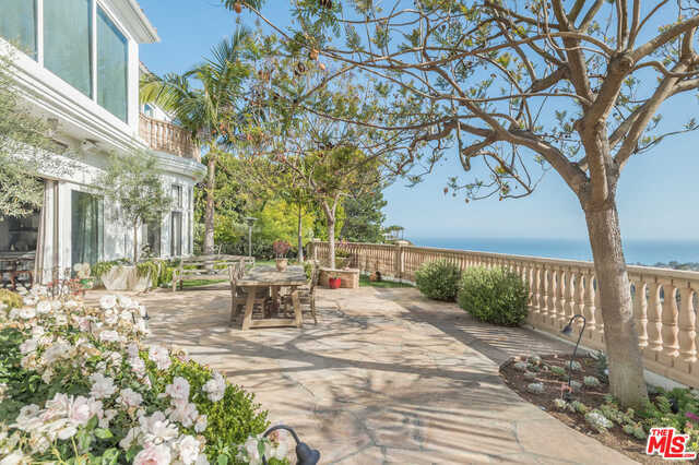Located in the 24-hour, guard-gated Ridgeview Country Estates, this enchanting modern Mediterranean villa stuns with its unobstructed views of the ocean and Tuscan-style vineyard. Built by prominent architect Dan Lang, the spacious interior has a vast, open concept design. Upon entrance, the villa meets you with 31-foot-high ceilings, an opulent entry with a spiral staircase, and an expansive living space that melts effortlessly into the outdoor living area and infinity pool. The family room and bar is sure to be the center of all entertainment or find a moment to escape to the private library/office. Enjoy dinner parties in the formal grand dining room or create culinary masterpieces in the chef's kitchen that's finished in rare Brazilian blue lapis granite. Upstairs, the master bedroom and bathroom comes with sweeping dual walk-in closets and a secluded master balcony. This five-bedroom, six-bathroom romantic Mediterranean villa offers the perfect get-away feel all year round.