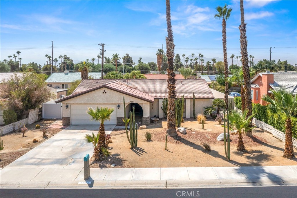 Discover refined desert living in this beautifully appointed 3-bedroom, 2-bath residence tucked within the sought-after Rio Vista neighborhood of Cathedral City. Designed with an open-concept floor plan, this home offers a seamless flow between the living, dining, and kitchen areas—ideal for entertaining and relaxed everyday living. Once inside, the home’s step-down living room creates an elegant focal point, framed by expansive windows that fill the space with natural light. There’s plenty of room for a large TV and comfortable seating, making it perfect for both quiet evenings and lively gatherings. The chef-inspired kitchen is appointed with sleek stainless-steel appliances that include a refrigerator, oven/stove, dishwasher and microwave. A spacious kitchen island perfect for serving or casual barstool dining and a seamless connection to the dining and living areas- making this area the true heart of the home. The primary suite is a tranquil retreat and large enough for a king-size bed. It features sliding glass doors that open directly to the extra-large sized backyard, an en-suite bathroom and a generous walk-in closet for all your clothes and shoes. The second bedroom offers comfortable proportions while the third bedroom, complete with a good-sized closet, is currently styled as an office—both bedrooms providing flexibility to suit your lifestyle needs. Step outside to your private backyard oasis, perfectly suited for al fresco dining, gatherings under the stars, or tranquil mornings in the sun. The expansive backyard is a true blank canvas, offering endless possibilities. Add a sparkling pool, create a cozy fire pit gathering space, bring in RV parking or design a storage shed or workshop. Whatever your vision, this outdoor space is ready to be transformed into your personal desert retreat. Enjoy the benefit of FULLY PAID SOLAR panels, combining modern efficiency with peace of mind. With its blend of sophistication and comfort, this home embodies the best of the desert lifestyle. ~Welcome Home~