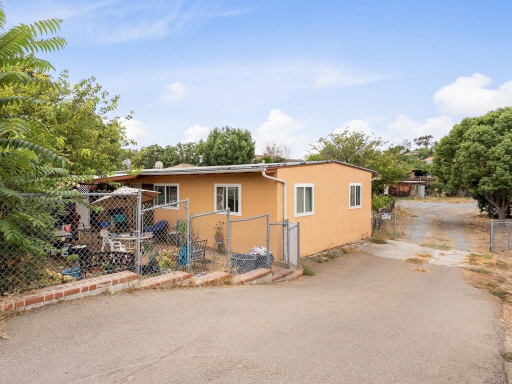 Located on a 0.41 acre lot, this property presents as a 3 bedroom, 1 bathroom home with a separate 2 bedroom, 1 bathroom living space with its own entrance. Each has its own full kitchen and laundry areas, dual paned windows, and long term tenants. A variety of fruit trees are located on the property, including lemon, persimmon, avocado trees, and more, along with front and rear patio spaces. This Los Coches property is close to SR-67 access, Lakeside County Park, Lindo Lake, shopping, and restaurants, and awaits its new owner. Buyer may research if additional opportunities for the property and lot exist, whether ADU, pool, landscaping design, etc.