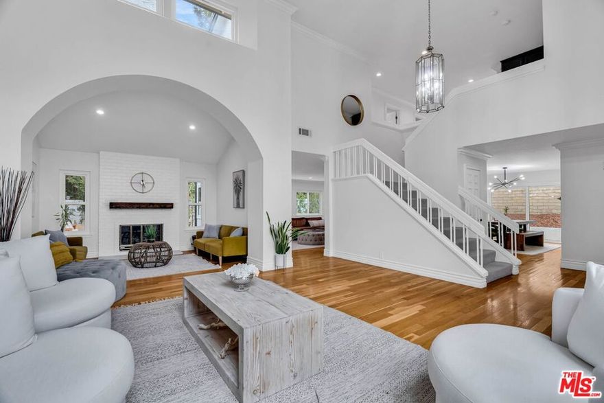 Welcome to this beautifully updated, move-in ready home nestled in a desirable pocket of Thousand Oaks! This spacious 4-bedroom, 2.5-bath home offers the perfect blend of style, comfort, and functionality! Step inside to an open living room with vaulted ceilings and abundant natural light! Just beyond is a den-style room featuring a charming fireplace. Head into the family room which flows seamlessly to the open, modern kitchen featuring a center island with bar-style seating, quartz countertops, premium built-in Thermador appliances and custom cabinetry--ideal for cooking and entertaining! A formal dining room, guest bath, and laundry room complete the main level. Upstairs, a loft-style foyer offers flexible space for work, play, or relaxation. The primary suite features LVP flooring, a spa-inspired bathroom with dual sink vanities, a soaking tub, a glass-enclosed shower, a separate vanity area and a walk-in closet. Three additional bedrooms enjoy peaceful views of mature trees. The spacious garage includes a converted third bay--an approx. 190 sq ft temperature-controlled bonus flex room, which was previously used as a recording studio and office. Additional highlights include: hardwood flooring throughout main level, recessed lighting and plenty of storage throughout the home, custom window roller-shades, a Nest thermostat, neutral interior colors, and a private low-maintenance backyard perfect for pets, entertaining or lounging! Located on a quiet cul-de-sac minutes from award-winning Lang Ranch Elementary, shops, restaurants, hiking trails, parks, and the 23 freeway, this home offers the perfect blend of comfort, convenience, and community! Over 3200 sq ft of useable living space AND there is no HOA!