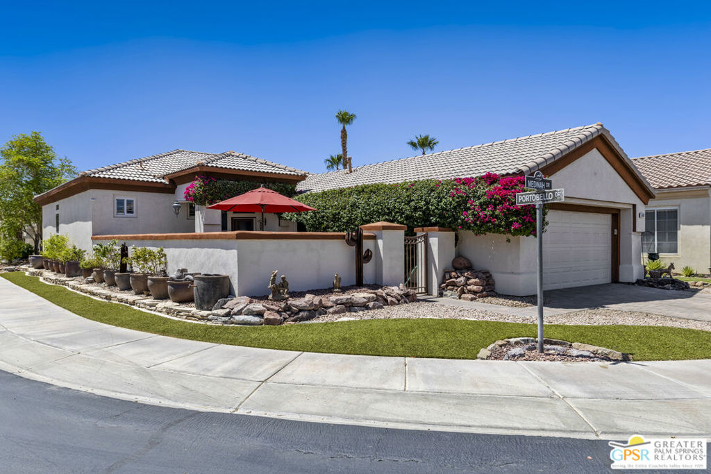 This little stunner shines from it's corner lot location. Note the artifical turf and potted plant garden as you arrive at the property. Step through the iron gate into the spacious semi-private walled patio/w custom built tables, and gas grill. Imagine yourself dining al fresco or cocktailing with friends. Just inside the front door, prepare to be awed. At first glimpse, you are greeted by gleaming beautiful hardwod floors w/contrasting white walls and custom lighting. Dramatic! Truly open concept living. The living/dining area has been extended, & large dual pane windows are the backdrop for this area with plantation shutters, btw...throughout the home, allowing for bright light or total privacy. At the end of the dining area is a outdoor access to a semi-private artifical turf covered patio area. The master suite includes a water closet, step-in shower, his and her vanitys, walk-in closet w/dressing area. The kitchen is spacious, yet effecient. Included is a breakfast bar and closet pantry. Walk down the hallway in back of the kitchen and you'll you'll find bedroom #2 w/a full bath across the hall, the laundry area and entrance to your 2 car garage w/epoxy floor. Note: Central heating and electricity. (IID.) Each room can be controlled independently.
