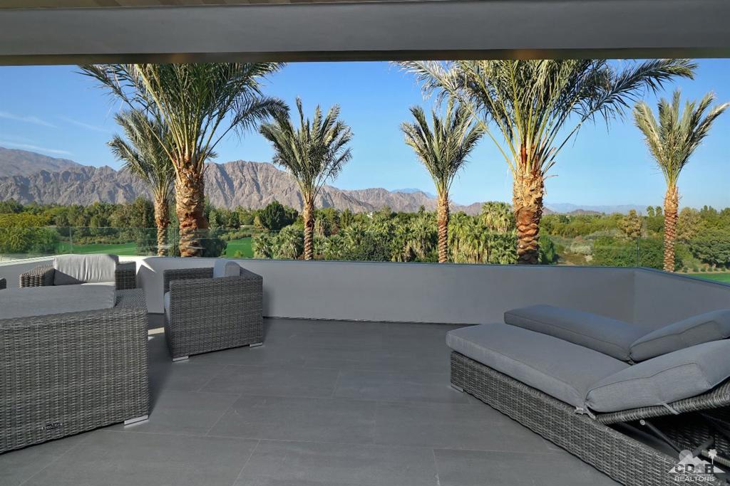 STUNNING VIEWS! This amazing, newly-constructed custom home boasts 12,000 + square feet of contemporary living space and spectacular views of the Santa Rosa Mountains and 6th and 7th holes of the golf course.