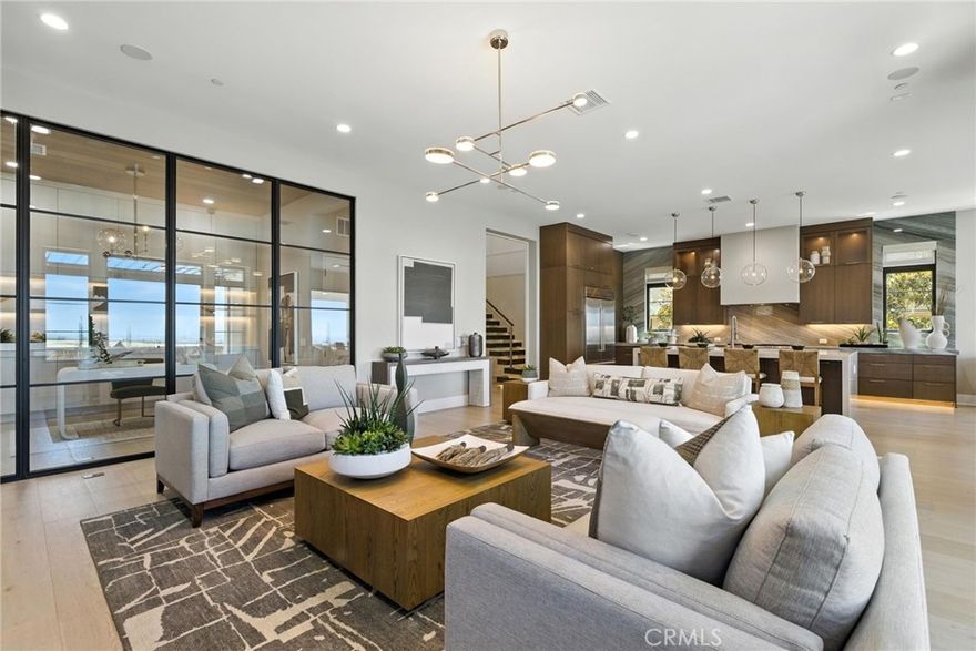 Pinnacle at The Summit at Orchard Hills by Toll Brothers – Homesite 0019. Experience refined luxury with the Addis floor plan, Italianate exterior, 5 ensuite bedrooms, 5.5 baths, approx. 4,579 sq. ft. of living space on a 6,483 sq. ft. homesite, with 2-car garage and pool-sized backyard. This rare single-loaded street offers privacy with no direct front or rear neighbors, while elevated city-light views extend toward Newport and Catalina Island. Designed for modern living, the home features a cantilevered steel floating stair with glass railing, 22’ stairwell ceilings, glass walls in flex spaces, and multiple Western multi-slide stacking doors for seamless indoor/outdoor living. Additional highlights include a downstairs suite and office, loft, 60” Primo fireplace, Wolf® and Sub-Zero® appliances, spa-inspired primary bath with Kohler® digital shower system, floating vanities with LED lighting, designer electrical and low-voltage selections, and a private primary suite deck. Estimated completion is Summer 2026, presenting a limited opportunity in Irvine’s most desirable staff-gated hillside community. Residents enjoy access to resort-style amenities, saltwater pools, parks, and acclaimed Irvine schools. Buyers still have time to personalize cabinets, countertops, and flooring. Photos are of the model home; actual home is under construction.