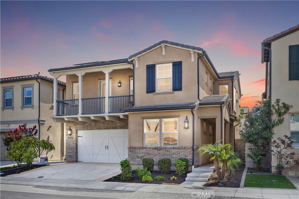 Welcome to 12932 Lotus Street, a truly exceptional home designed by Shea Homes. Built in 2019, this newer construction is in the gated Gardenia community. Original owners. This stunning home offers 2,581 sqft of living space, featuring 4 beds, 4 baths, an oversized loft, and a 2-car garage with a full driveway that provides direct access to the home. Dramatic two-story height ceiling at the formal entry create a grand and impressive welcome. Inside, the formal living room showcases tiled flooring, an elegant dining area, and custom wood shutters. The chef’s kitchen is equipped with white shaker cabinetry, quartz countertops with a full backsplash, granite countertops on the island, and stainless steel appliances including a 5-burner cooktop, over-the-range hood, microwave, oven, and dishwasher, centered around a generous island perfect for entertaining. The primary suite boasts a full-length balcony, a tile-to-ceiling oversized shower, brushed nickel fixtures, and a great size walk-in closet. Two additional bedrooms and a loft are also located on the second floor, along with a laundry room featuring a utility sink. Energy-efficient upgrades include a conduit for future EV charging, dual-glazed windows, a tankless water heater with a recirculation pump, a quiet cool house fan, and LED lighting throughout. FULLY PAID solar panels add to the home’s sustainability. Enjoy the convenience of nearby top-rated restaurants, shopping centers, easy freeway access, and a private community park for outdoor activities. Ideally located just blocks away from Disneyland and The outlets at Orange, this home offers luxury, comfort, and unbeatable location.