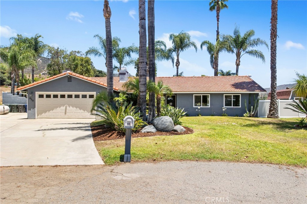 Welcome to a beautifully upgraded single story home in Escondido that offers the perfect blend of indoor comfort and outdoor space. Set on almost an acre of fully usable land, this home features three bedrooms, two bathrooms, a two-car garage, and a versatile office that can easily be turned into a fourth bedroom. The home is also equipped with solar for energy efficiency. The interior has been tastefully finished with wood-look tile flooring throughout, new windows, and a kitchen that offers stainless steel appliances, custom countertops, and built-in cabinetry. The layout is functional, open, and designed for easy everyday living. Out back, the private yard offers a true escape. Enjoy the pool and spa, entertain at the built-in BBQ, or relax under the AlumaWood patio cover. Palm trees and fencing create a peaceful, resort-like setting. One of the most unique features is the expansive side yard, completely usable and ready for your vision. Whether you need space for work vehicles, RVs, a business setup, or future plans, the potential here is unmatched. The property also includes full RV hookups with a 30-amp circuit, water, and sewer, making it ideal for RV living or hosting. To top it off, the home includes a private ADU with its own kitchen, bathroom, and laundry hookups, perfect for guests, extended family, or rental income. With solar panels, a quiet yet accessible location, and unmatched versatility, this home truly offers something for everyone. Schedule your private tour today and come experience it in person.