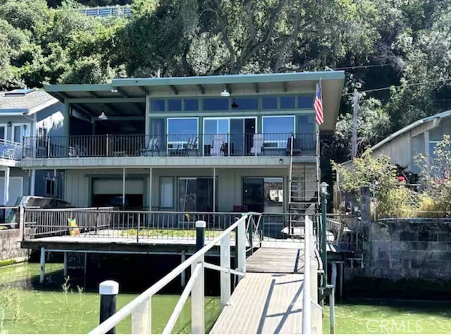 Waterfront home with amazing panoramic lake and mountain views in the rarely listed Westside Baylis Cove neighborhood. Remodeled kitchen and baths, laminate wood flooring in living room and kitchen. Wrap around deck and spacious lower patio. Pier, dock, boat ramp, 3 car carport area. And boat / car garage with drive through for launching boat. Beautiful sunrises and sunsets. Come, stay & leave your cares behind in Baylis Cove! Currently AirBnB.
