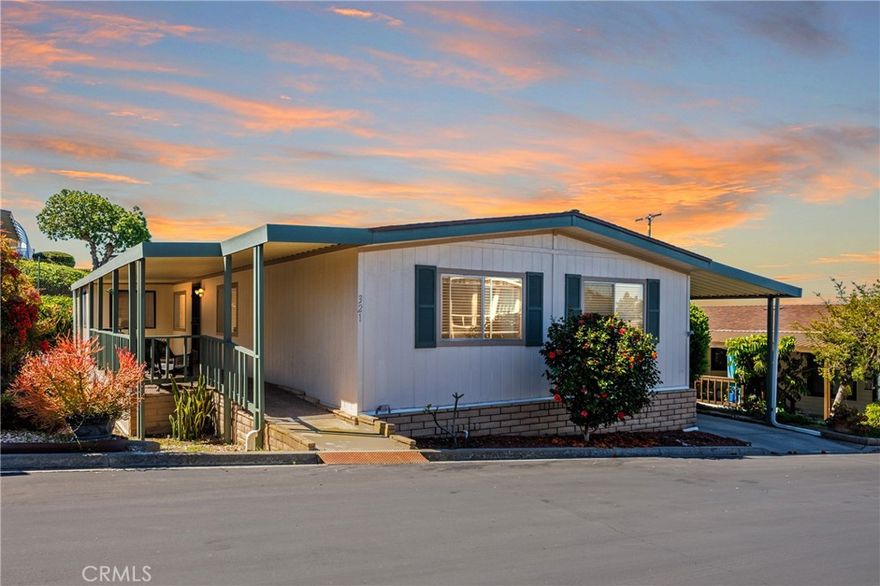 "In the rolling hills of northern San Diego County, nestled in the charming city of San Marcos, there stands a home—not just any home—but a hidden gem, waiting to be discovered. A sanctuary wrapped in sunlight and serenity… a mobile home, yes, but so much more than meets the eye."

Here, in this peaceful enclave, lies a single-level residence, designed with intention and grace. Surrounding it, lush landscaping bursts with life—every bloom, every leaf, a testament to care and quiet pride.

Sheltered beneath a private carport, the home welcomes you into a world of unexpected spaciousness. You step inside to find a balance of elegance and warmth: a formal living room and dining room, perfect for gathering under soft lighting and shared stories. Just beyond, a cozy family room invites connection, while the breakfast nook offers a sunny corner for slow mornings and coffee-fueled reflections.

The fully equipped kitchen—the heart of the home—stands ready for culinary adventures, whether it’s Sunday pancakes or cherished holiday feasts.

And oh, the luxury of convenience: an inside laundry room, tucked thoughtfully within reach, and three generously-sized bedrooms, each a restful retreat.

But it is the primary suite that steals the breath. Expansive and tranquil, it holds a bonus office or den—a quiet space for dreams to be penned, plans to be drawn, or simply a moment of stillness.

Above it all, skylights bathe the home in golden California light, weaving warmth through every hallway, every room.

Outside, tucked just off the carport, a workshop waits—whether for tools, tinkering, or the seeds of new ideas.

Yet the story does not end at the doorstep. This home lives within a vibrant community, where neighbors gather at the community center, and laughter dances across the pool deck on warm afternoons.

This is more than a home.
It’s a chapter waiting to be written, a life waiting to unfold, in the heart of San Marcos. And for the one who finds it… it will never be just a mobile home again.

It will be home.