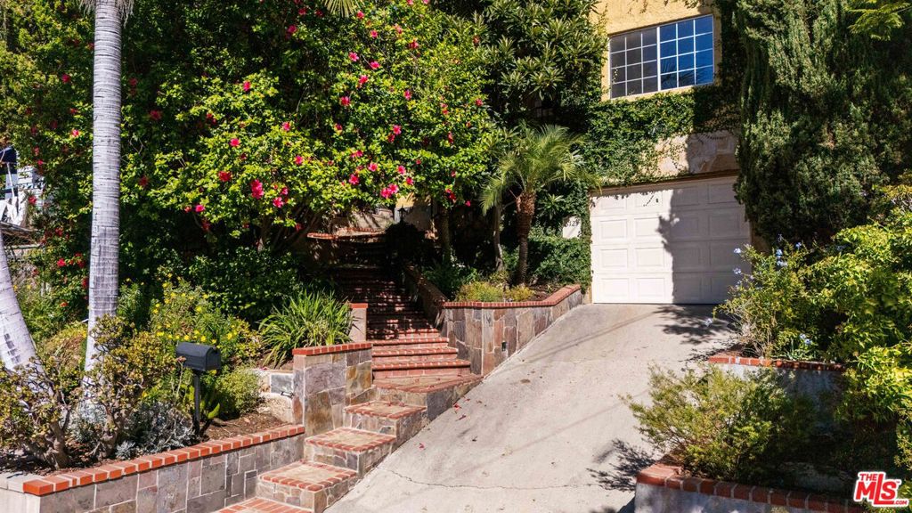 Lovingly updated by its current owner, this 3 bedroom, 3 bathroom, 1,683 square foot home in El Sereno, offers a layout with flexibility and flow where every detail has been considered. The home's original charm remains intact: warm light, built-ins, custom light fixtures, and thoughtful touches throughout make it feel lived-in in all the right ways. On the main floor, two guest bedrooms share a newly remodeled bathroom, while the upstairs full-floor primary suite feels like a private hideaway complete with a bonus space perfect for a study, yoga nook, or dressing room. Off the kitchen, a separate bonus space with its own entrance and full bathroom offers endless possibilities: art studio, guest suite, or creative office. Outside, the vibe continues. The front yard sits elevated from the street, surrounded by lush, irrigated landscaping for privacy and peace. Out back, a newly remodeled flagstone patio with barbecue invites long summer nights under string lights. There's parking in the garage plus additional space in the driveway, a large laundry room, and plenty of storage throughout. Located on a quiet, tree-lined street in the heart of Northeast LA, El Sereno is having a moment. It's central to Highland Park, South Pasadena, DTLA, and all the Eastside has to offer. Here, you'll find warmth, light, and ease.