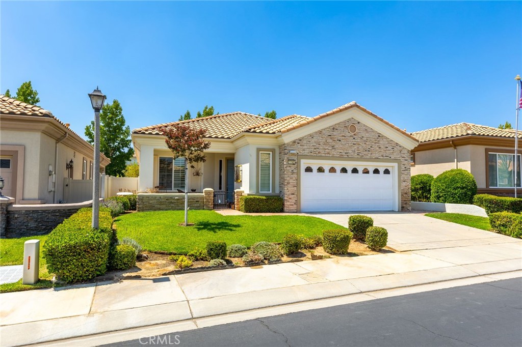 Welcome to 1742 Litchfield, a beautifully maintained home located in the highly sought-after 55+ community of Sun Lakes Country Club. This light-filled 2-bedroom, 2-bath residence offers a comfortable 1,683 sq. ft. of living space with an open and functional floor plan perfect for both relaxing and entertaining. Step inside to find a spacious living room with high ceilings, a cozy fireplace, and large windows framing serene views. The kitchen features ample cabinetry, generous counter space, and a breakfast nook that opens to a private patio—perfect for morning coffee or evening sunsets.
The primary suite boasts a walk-in closet, dual-sink vanity, and a sliding door to the backyard, allowing you to enjoy the peaceful surroundings right from your room. The guest bedroom and full bath provide a welcoming space for visitors. Living in Sun Lakes means enjoying resort-style amenities, including 2 golf courses, 3 clubhouses, pools, tennis & pickleball courts, fitness centers, and a variety of social clubs and activities. All of this is conveniently located near shopping, dining, and easy freeway access. Don’t miss the opportunity to make this charming home yours and start enjoying the Sun Lakes lifestyle today!