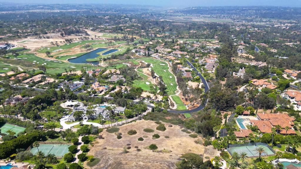 Set within the exclusive Spyglass Estates in the guard-gated community of Rancho Santa Fe Farms, this 2.29-acre lot offers an exceptional opportunity to build a custom estate in one of San Diego’s most prestigious neighborhoods. With elevated terrain and westerly exposure, the property enjoys sweeping views of the Farms golf course, city lights, and the Pacific. Included are HOA-approved plans by renowned architect Mark Morris for a 10,000+ sq ft Spanish Contemporary residence, currently pending county approval. This stunning design features soaring ceilings, expansive windows, main-level living, and a second-floor entertainment wing with a theater. Plans also include a meditation room, 8-car garage, and 1,200 sq ft guest casita, along with a full-size tennis court (convertible to pickleball) and a beautifully designed motor court entry. Alternatively, the lot provides ample space and flexibility to bring your own vision to life. Rancho Santa Fe Farms is centered around a top-ranked golf course and just minutes from Rancho Valencia, world-class dining, beaches, and top-rated public and private schools. This is your rare chance to build in a premier Rancho Santa Fe location.