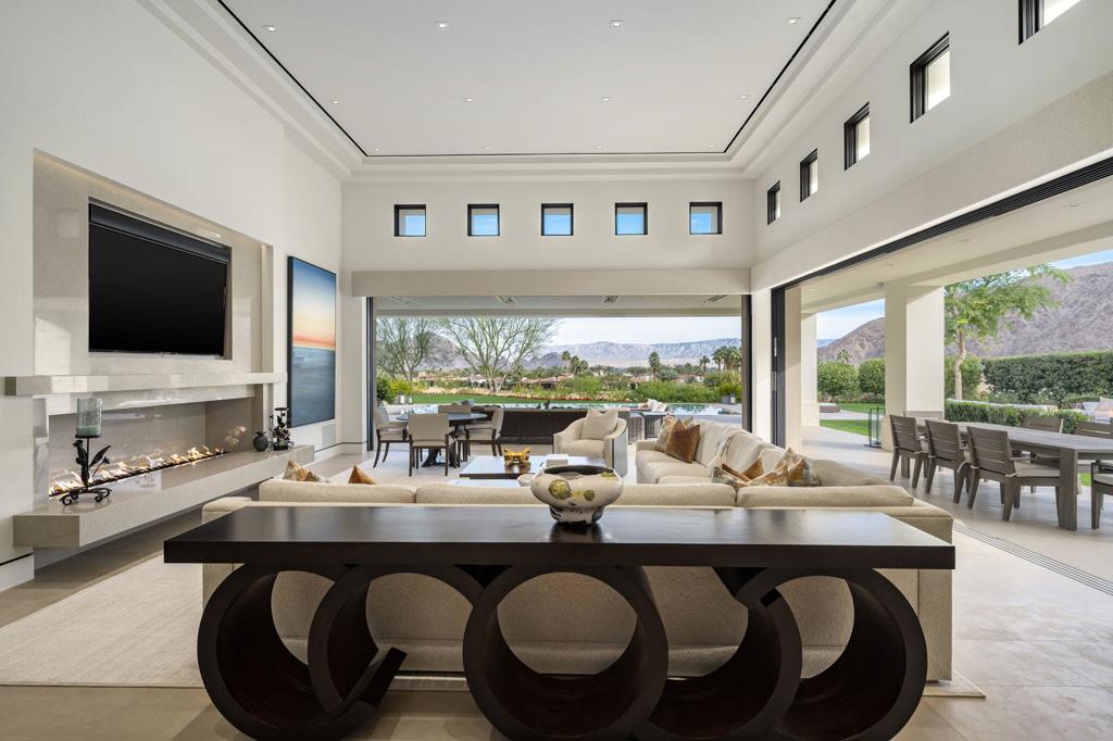 Simply The Best! Modern clean design, wide open floor plan with endless pocket doors & panoramic views. Completely remodeled in 2018 replacing every surface, window, door, electrical, plumbing, HVAC and even the roof. No expense was spared, using only the finest and unique materials, with and perfect attention to detail. Built on one of the most prized lots at the top of Tradition with down valley golf and city lights views, an expansive lawn, resort size pool and fire pit, outdoor kitchen and spacious private courtyard - perfect for dog lovers and large family gatherings. Huge, covered patios with heaters and misters allow indoor/outdoor entertaining in both great room & dining room. Sparkling tile-bottom zero-edge pool and spa floating above the 12th fairway with Privacy and Tranquility. Steel entry door system, soaring ceilings, incredible Kitchen with giant quartz island and great breakfast nook. Huge master suite with gorgeous wallpaper, linear fireplace, handsome sitting area, and glass lined gym. Ultra-lavish statuary slab marble master bath with the most amazing closet with washer + dryer and cabinets galore. The 4 spacious guest rooms feature textured wallpaper and baths with many luxurious onyx slab counters & showers. Fantastic casita with large living room, kitchenette, & bedroom. Motorized rolling shades throughout, One touch lighting system, Control 4 AV system & smart house features. Sheer perfection. Offered designer custom furnished per Inventory.