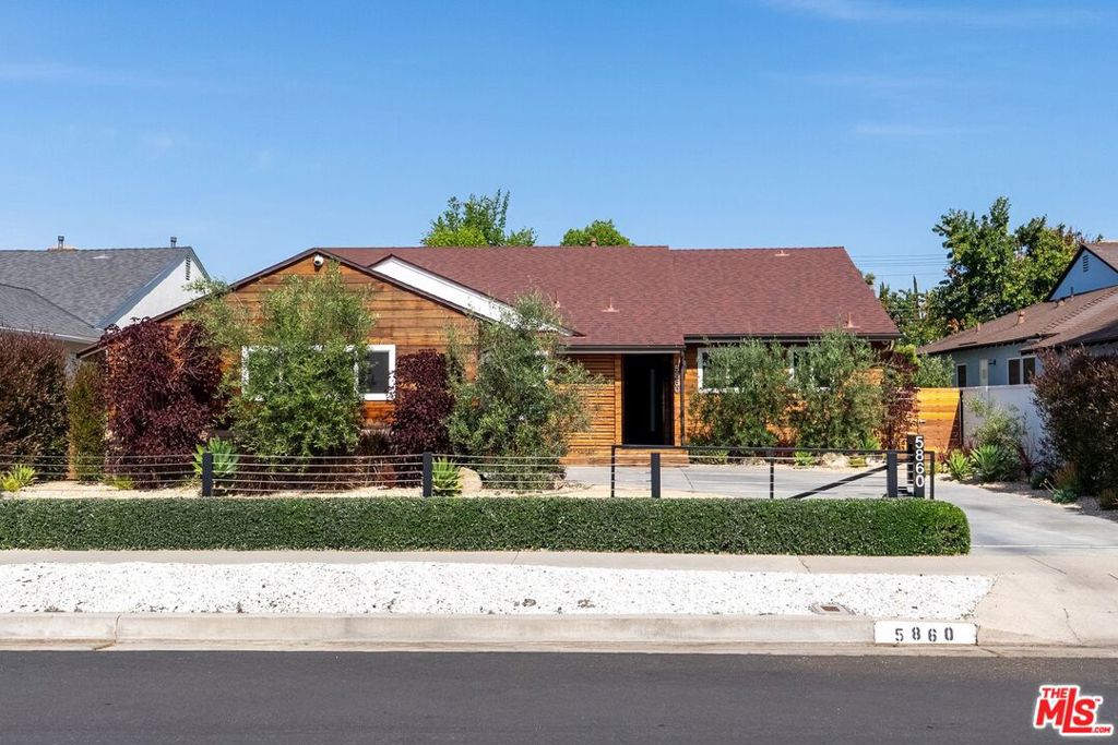 Thoughtfully remodeled Valley Village home. Beyond the gated entry of this reimagined single-story 4-bedroom, 4-bath residence, a fresh landscape and striking wood-panel facade create unforgettable curb appeal. Inside, the open layout flows with engineered wood floors cushioned by " cork, blending comfort with elegance. Recessed lighting, crisp white walls, and a sleek fireplace set a serene tone in the main living area.Entertain with ease in the custom-built family nook complete with an integrated beverage cooler, or host guests around the waterfall bar in the chef-inspired kitchen, featuring brand-new stainless steel appliances and ample cabinetry. Your expansive primary suite offers direct outdoor access, generous closets, and a contemporary ensuite with an oversized frameless shower.Slide open glass doors to your private oasis: a wide deck perfect for gatherings and a new saltwater pool with a tranquil water featureideal for summer days. Tech-forward upgrades include an updated A/C, alarm system with cameras, water filtration throughout, and a newer roof. A tucked-away laundry alcove and a 2-car garage add convenience.Situated on a tree-lined multi-generational street, it's mere moments from the Tujunga Greenbelt and various cultural centers, while a short drive puts you within reach of the NoHo Arts District, LA Valley College, Harvard Westlake, the 170 Fwy, and Griffith Park.