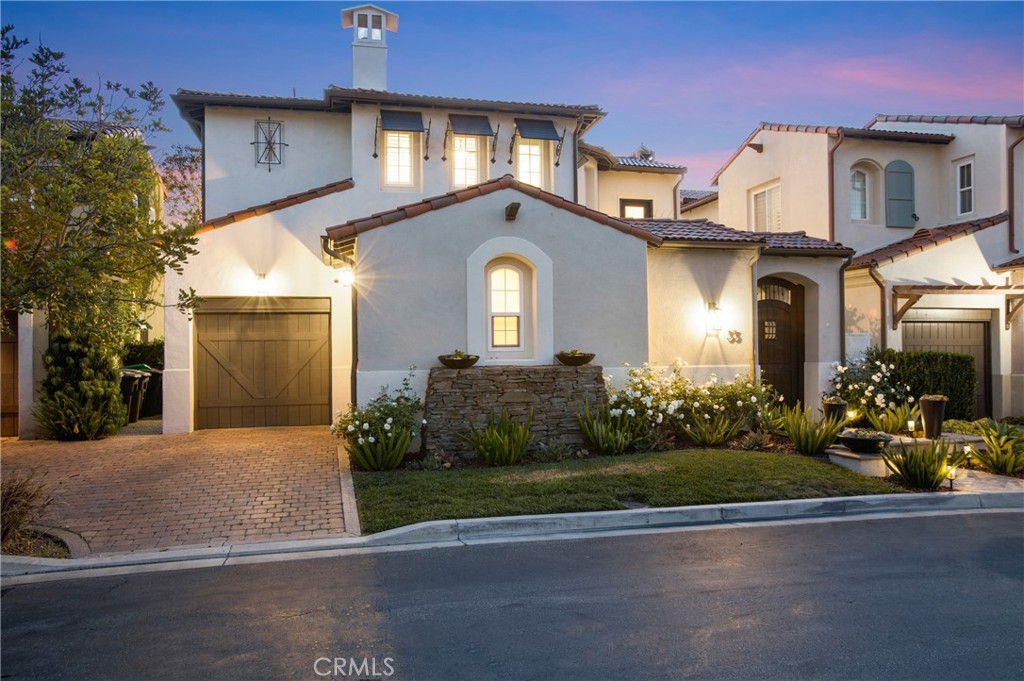 Perched on a premier view lot within the gated enclave of Tesoro, this Tuscan-inspired residence captures panoramic views of the Pacific Ocean, Catalina Island and vibrant coastal sunsets. Enjoy an ever-changing tableau of blue water, rolling hills, and golden skies—offering an ambiance of refined coastal living. Thoughtfully remodeled throughout, the home features a desirable 4-bedroom layout designed for both everyday comfort and stylish entertaining. At its heart lies a chef’s kitchen, appointed with custom cabinetry, Calacatta quartz countertops with full height backsplash, and a full suite of premium built-in refrigeration—including a full-size refrigerator, matching freezer, and integrated wine column.
The open-concept floor plan effortlessly transitions to a resort-inspired backyard, complete with a covered outdoor kitchen and bar, oversized television, stone fireplace, and multiple areas for lounging and dining—perfect for casual gatherings or elevated entertaining. Fireplaces grace both the interior and exterior spaces, creating warmth and ambiance throughout. The primary suite is a true sanctuary, showcasing dual custom walk-in closets and a spa-like bath with a walk-in shower, deep soaking tub, dual vanities, and designer tile flooring. Additional features include rich stone flooring, detailed moldings, and sun-drenched living spaces that blend warmth with sophistication.
Ideally situated near top-ranked schools, toll roads, parks, shopping, and resort-style community amenities—including direct private access to Newport Coast Elementary—this exceptional home offers the perfect blend of luxury, location, and lifestyle.