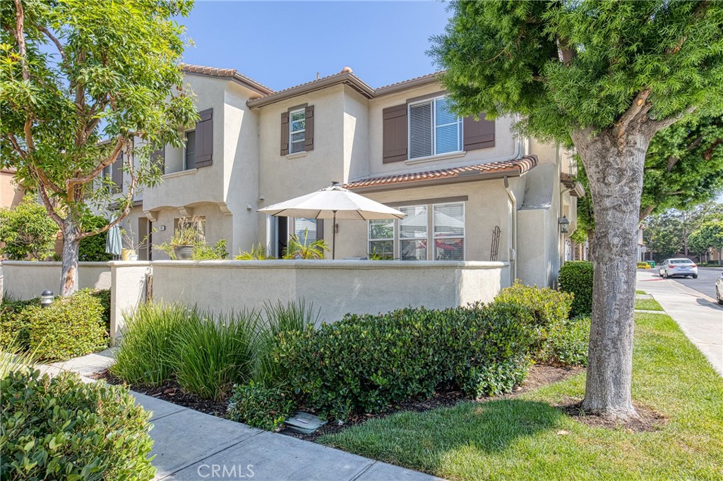 This beautifully maintained end-unit residence perfectly combines modern elegance, comfort, and an ideal location. From the moment you enter, you’re welcomed into a spacious open floor plan with a light-filled living and dining area. Tile flooring, recessed lighting, a ceiling fan, fireplace, and built-in entertainment center create a warm yet sophisticated setting. French doors open to the private patio, thoughtfully designed with built-in planters—an inviting retreat for entertaining or enjoying a quiet afternoon outdoors. The kitchen has a quartz countertop with white cabinetry, stainless steel appliances, gas cooking, and a walk-in pantry, offering both style and convenience for everyday living. Upstairs, a versatile loft with built-in desk provides the perfect space for a home office or study. The primary suite is a private retreat featuring recessed lighting, a ceiling fan, dual vanities, a separate soaking tub, a walk-in shower, and a spacious walk-in closet. Two additional bedrooms share a full hallway bathroom, with one room enhanced by a charming bay window and seating area. Additional highlights include laminate wood flooring throughout the upstairs, fresh interior paint, recessed lighting throughout, a direct-access two-car garage, and all appliances including a refrigerator, washer, and dryer. Ideally located within the award-winning Beckman High School district and within walking distance of Myford Elementary, this home also offers easy access to West Irvine’s scenic trails and parks. Blending style, comfort, and prime positioning, this residence is truly move-in ready.