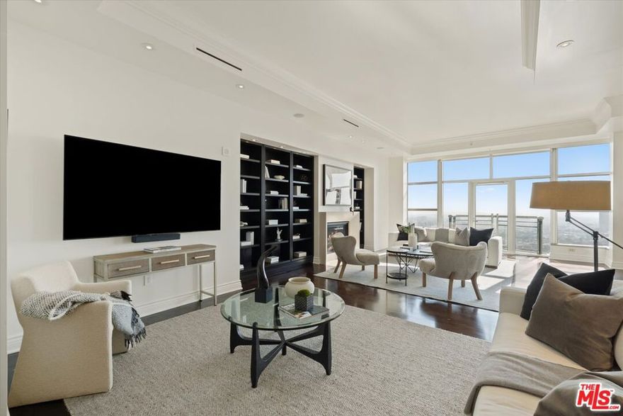 Unit 1904 at The Carlyle Residences is a coveted, 3,535 sq ft residence PLUS an additional 500+ sq ft housekeeping unit on the second floor and a valuable third parking space, making the total combined living space just over **4,000 square feet**. This additional, separate space features a convenient kitchenette and a full bathroom, perfect for staff quarters, a secondary office, or an additional guest room. The 19th floor residence offers 3 bedrooms / 3.5 bathrooms, and two balconies. The home provides unrivaled south-west exposure, showcasing cinematic views of the Pacific Ocean and the Los Angeles skyline; it also provides north facing views with a full display of The Getty and mountains. An exclusive, direct-access elevator opens into your private foyer. The interiors exhibit dramatic 11 ft ceiling height, hardwood floors, a fireplace, and a professional chef's kitchen with premium Miele appliances. The serene primary retreat includes a spa-like, marble-clad primary bathroom, a dedicated private office, and an extra large closet. Residents enjoy 5-star white-glove service (24-hour Valet, Doorman, Concierge) and world-class amenities including a heated pool, designer fitness center, and private wine storage.