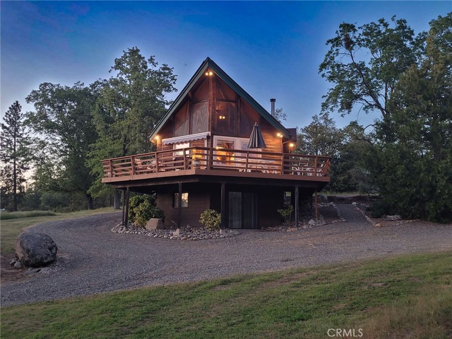 Welcome to your scenic retreat, a custom three-story mountain cabin set on 15 stunning acres across three APNs with the Middle Fork of the Chowchilla River running along the western edge. This property offers sweeping views, abundant wildlife, and the ideal setup for horse lovers. The middle 5 acre parcel has all building improvements and the adjoining two parcels are vacant. 
The home features 2 bedrooms, 2 bathrooms, a loft that sleeps 8, a main-floor bedroom and bath, and a private master suite on the lower level with a den, office, and full bath. Floor-to-ceiling windows bring the outdoors in, and each level has its own deck or patio to enjoy the peaceful setting. There is also an additional exterior bathroom with electricity, hot water, and a shower. 
Designed for equestrian living, the property includes an 8-stall barn with water and power, 7 outdoor stalls, a ½-acre riding arena, and 4 fenced turnouts. A second barn offers a bunk room, fridge, wood stove, pool table, and gym equipment—great for guests!
Extras include a garage with storage, 50-amp RV hookup and dump station, plus recent updates: AC (2022), water heater (2023), and electrical (2021). Strong cell service, plenty of room for parking, and most furnishings are included. 
Just 30 miles from Yosemite, this rare retreat is where rustic charm, wide-open beauty, and equestrian dreams come together in perfect harmony.  All this for $775,000.  There is also the option to purchase 10 acres with the home, rather than the full 15 acres, for $695,000. Call the listing agent for more details!