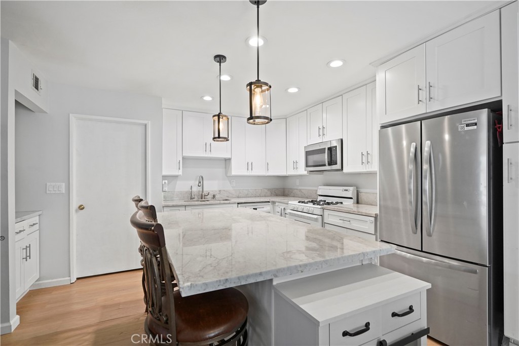 Live in comfort and convenience with this upgraded 2-bedroom, 2-bathroom residence, offering a coveted single-level floor plan with zero stairs. The newly redesigned kitchen is a chef's delight, ready for your culinary creations, while the freshly upgraded bathroom provides a spa-like retreat. Durable laminate floors and an abundance of storage space make this home as practical as it is beautiful. Step out onto your choice of two large patios—perfect for morning coffee or evening entertaining. The attached, direct-access 2-car garage ensures secure parking and easy entry. Plus, with the HOA taking care of water, trash, and sewer, you can enjoy low-maintenance living in a beautiful community