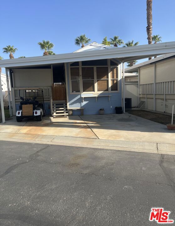 This park model is located on a quiet green belt within the middle of the community, giving easy access to all the activities. The patio is enclosed with automatic shutters to create an enclosed area. The shed is accessible right off the back stairs as well as a small outside patio. This all located in a 55 community that has a 3 par golf course, chipping green, putting green, 9 hole mini golf, pickleball and tennis courts, bocce ball, an indoor shuffleboard courts, 2 clubhouses with pools and Jacuzzies and an additional 4 satellites with pool, jacuzzi and mail boxes. This is all within a 24 hour gate guarded community ,of 801 lots, that consist of a combination of Park Models and RV lots, where you own the land. The resort has a limit of 270 day occupancy. It is. a perfect place to spend your holidays in the sunshine.