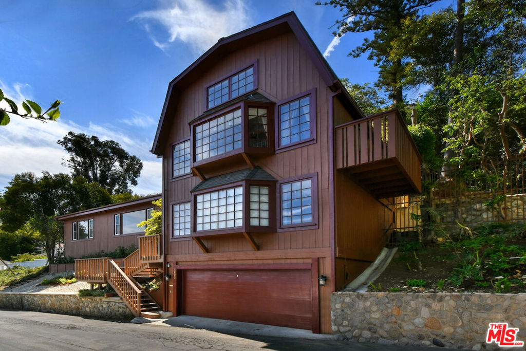 Located south of the Boulevard in the hills of Studio City, this lovely artist retreat offers incredible jetliner views of the San Fernando Valley with 3 bedrooms, 3 baths, and a two-car garage. Separate from the main living space and above the garage is the versatile 3rd bedroom with three-quarter bath that can serve as a bedroom, office, studio, or creative space. Continuing up a few more flights of stairs, the front porch greets you with sweeping valley views, while inside you'll find rustic charm throughout, including a super clean kitchen with detailed millwork, a spacious living room with fireplace and floor-to-ceiling windows framing incredible views. And on its own side of the home, the primary retreat includes ample closet space and a vintage tiled three-quarter bath while on the opposite side of the home, a unique bedroom with spacious loft has soaring ceilings, lots of closet space, its own three-quarter bath, and views. Located in Carpenter School district, and down the street from many shops, restaurants, Fryman Canyon, the farmers market, and easy access to freeways. 3682 Berry is a great place to hang for a while.